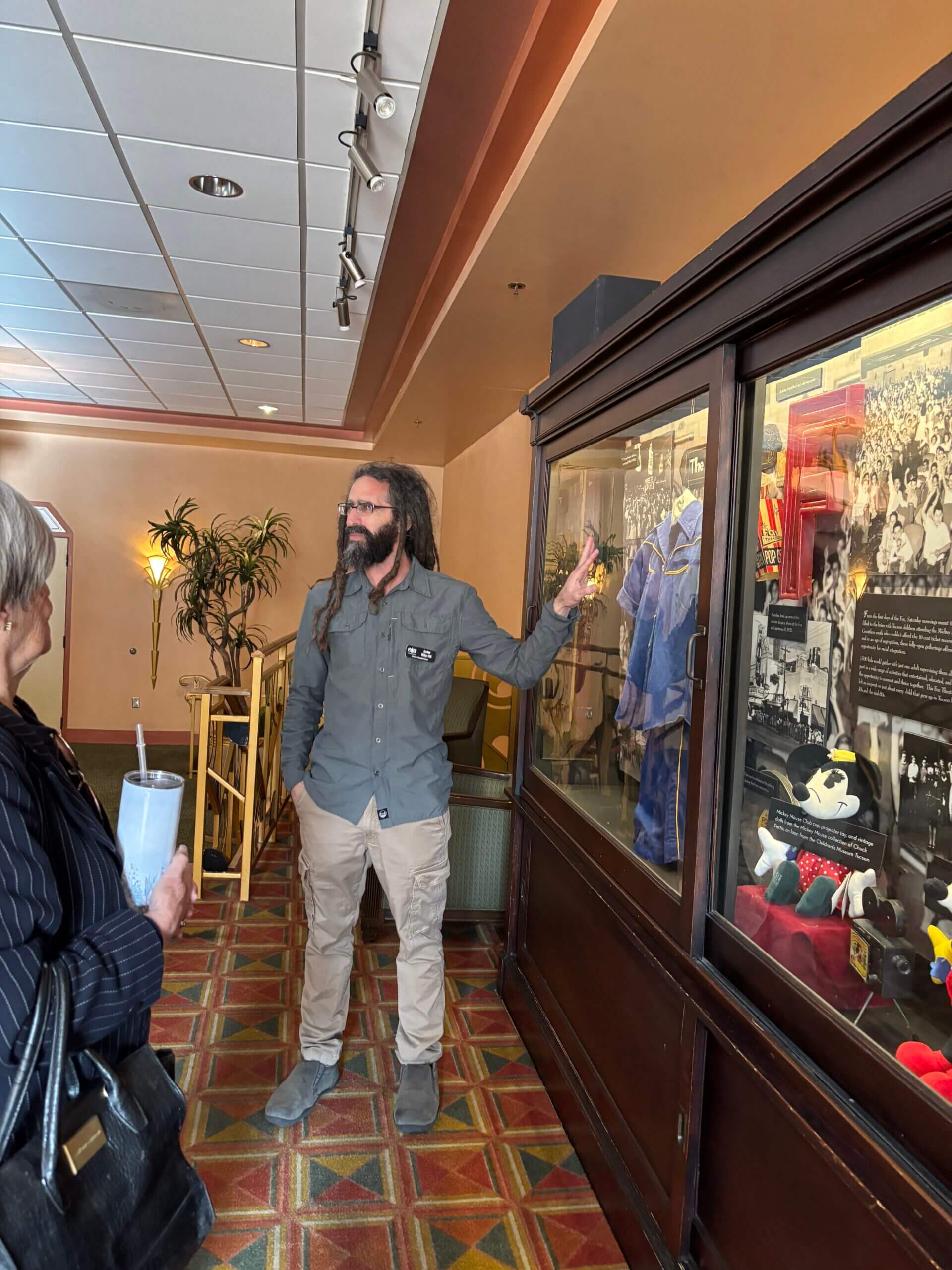 Visitor pointing at memorabilia display case