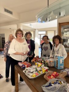 Women volunteers packing snack boxes on table