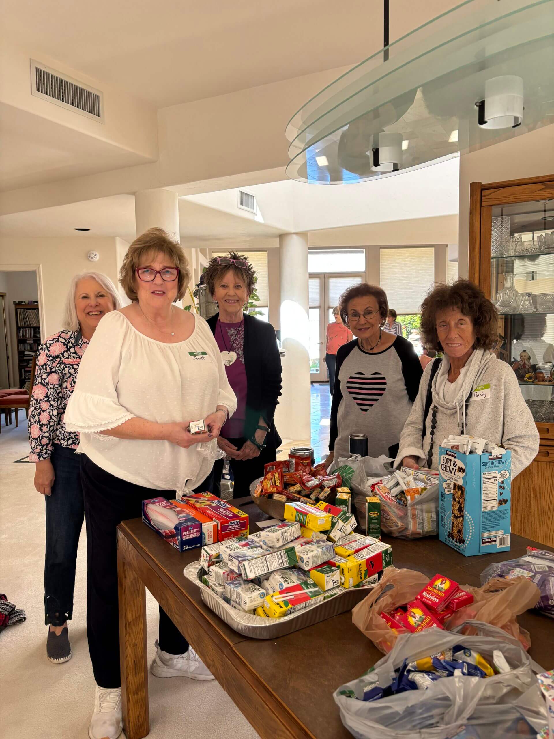 Women volunteers packing snack boxes on table