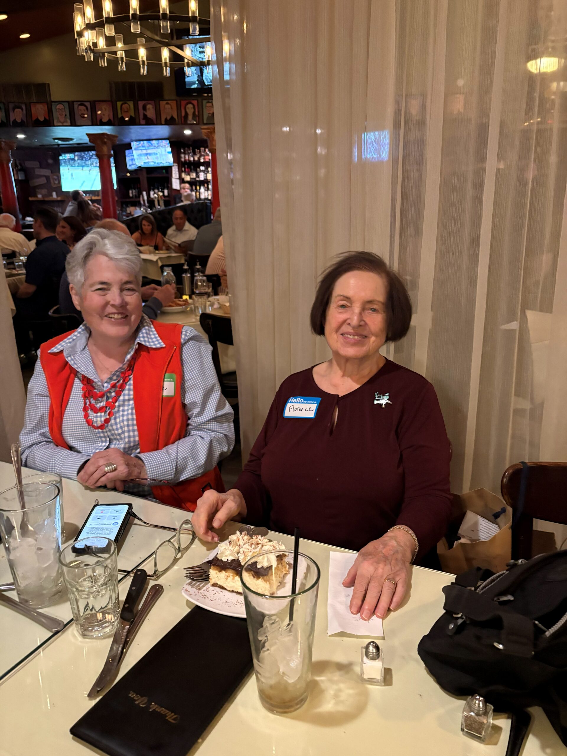 Two women at restaurant table with dessert