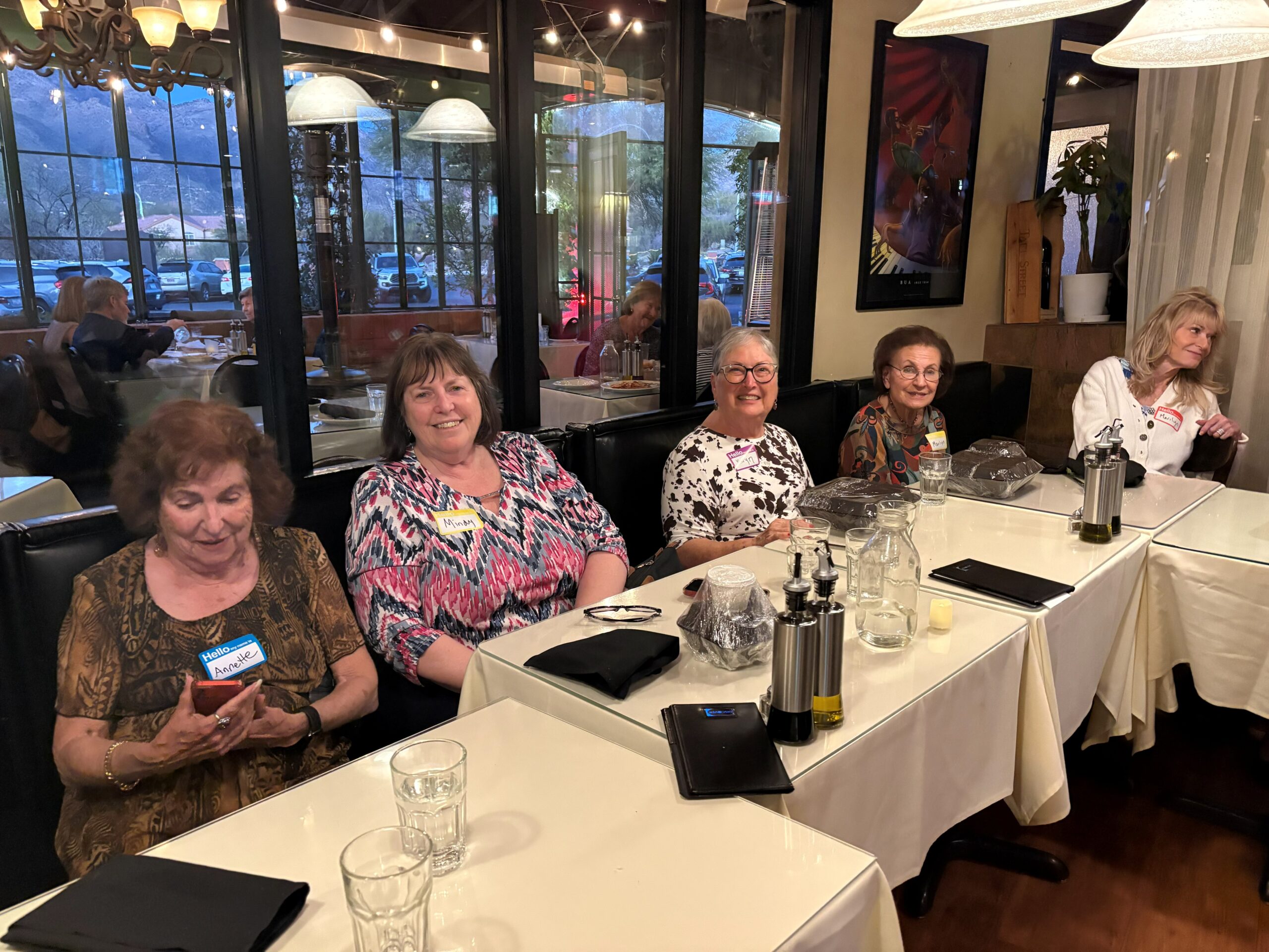 Five women seated at restaurant booth