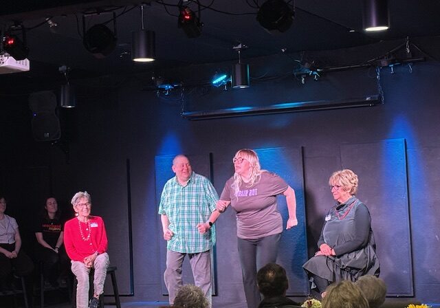 Improv troupe performing on small black box stage